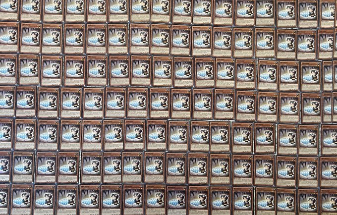 A grid of framed pictures, possibly Yu-Gi-Oh cards or similar game cards, arranged in neat rows and columns.