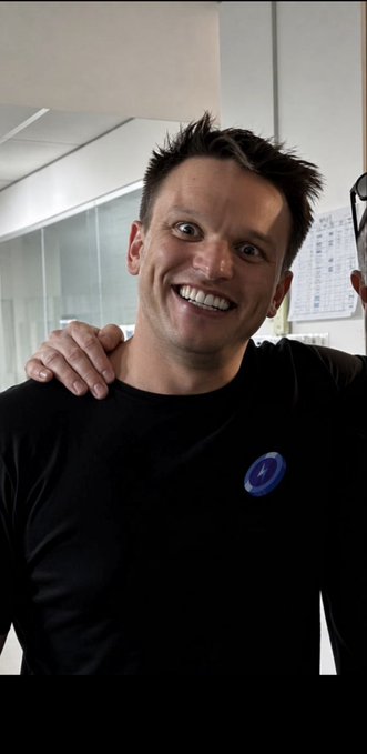 A man with a wide-eyed, excited expression is featured in this image, showcasing the "Stake" logo on his shirt, directly relating to the contest.