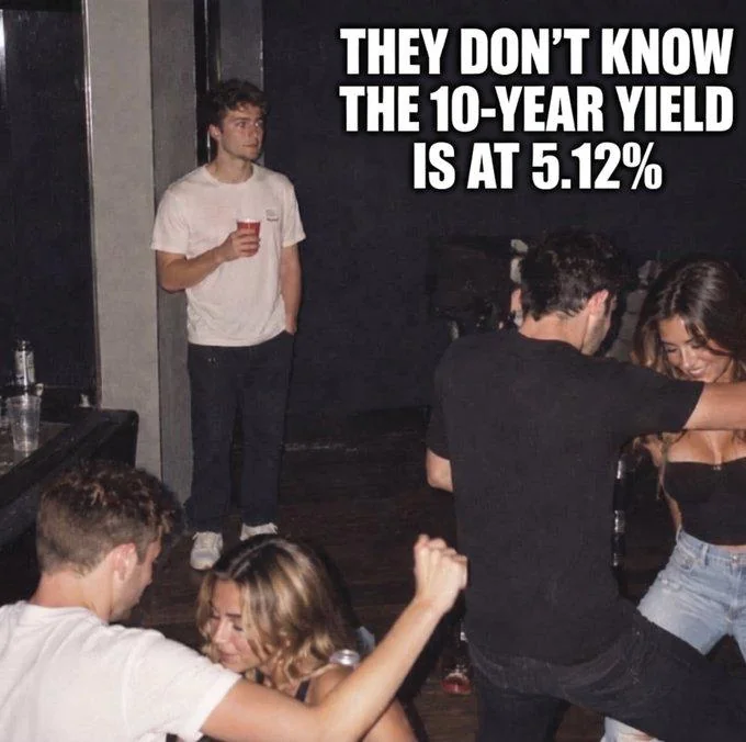 A meme showing a young man standing alone holding a red cup at a party, with the caption 'THEY DON'T KNOW THE 10-YEAR YIELD IS AT 5.12%'.