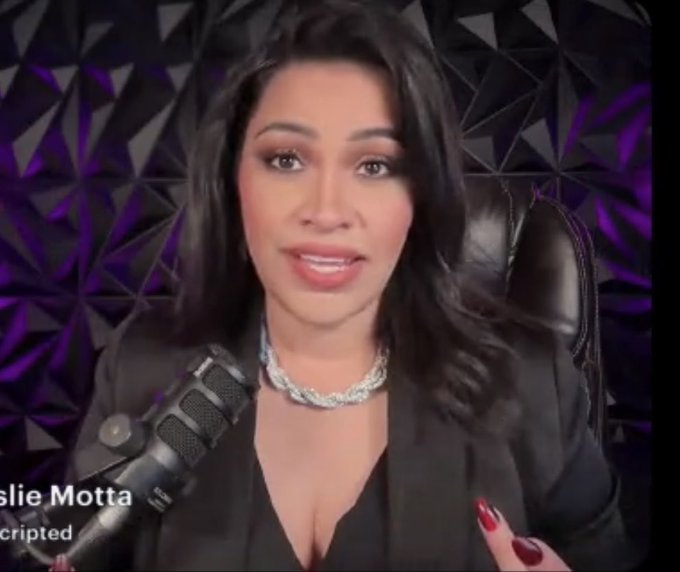 A woman named “Leslie Motta” appears in a video call, seated before a purple geometric backdrop with a microphone in front of her. The post relates to the image by discussing Hunter Biden and the launch of the $LAPTOP memecoin on Base, featuring a 1B supply, with 30% allocated to founders—including Biden—and 20% for airdrops.
