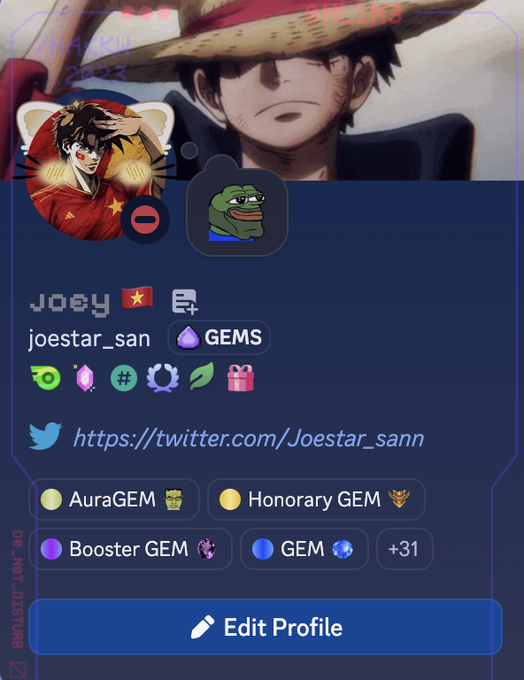 A social media profile card displaying the username 'Joey' with the handle 'joestar_san', a Twitter link to 'Joestar_sann', and various badges including 'AuraGEM', 'Honorary GEM', and 'Booster GEM'.