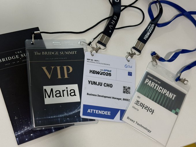 Three conference ID badges laid on a surface: "The BRIDGE SUMMIT" VIP badge for "Maria", "KBW2026" attendee badge for "YUNJU CHO" from Breez, and "PARTICIPANT" badge for "조마리아" Maria from Breez Technology.
