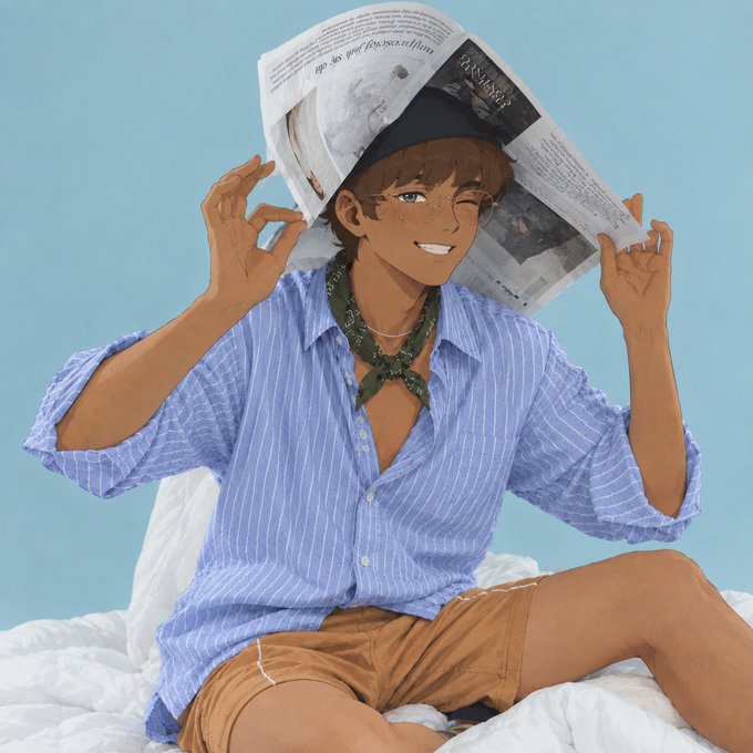 A digital illustration shows a smiling young man with brown skin and freckles wearing a blue striped button-down shirt with a green bandana, sitting on white bedding with a newspaper draped over his head.