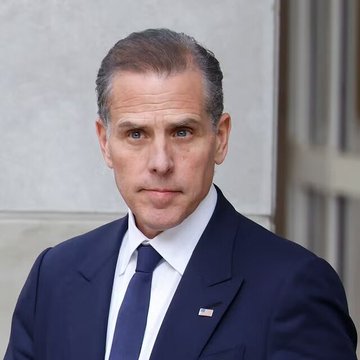Hunter Biden, the son of former President Joe Biden, is shown in a dark navy suit with an American flag lapel pin. The image likely relates to the post referencing Hunter Biden's launch of a $LAPTOP meme coin, capitalizing on his public controversies.