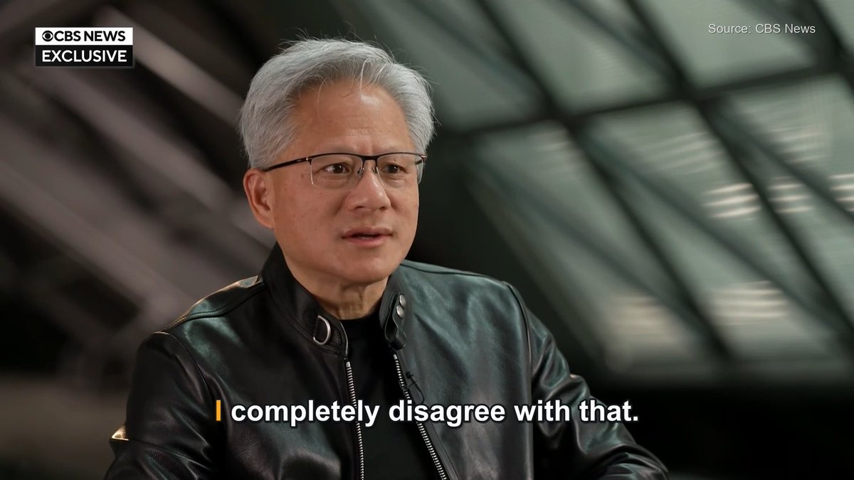 A CBS News Exclusive interview featuring Jensen Huang (NVIDIA CEO) wearing a black leather jacket, with the on-screen subtitle "I completely disagree with that."