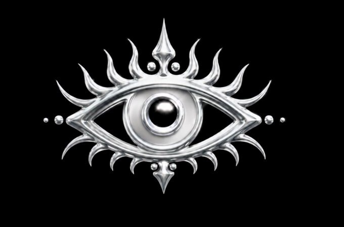 A silver metallic eye emblem with flame-like rays extending outward, centered on a black background, featuring a dark pupil and decorative beaded accents.