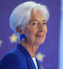 A portrait of Christine Lagarde, President of the European Central Bank, standing in front of the European Union flag.
