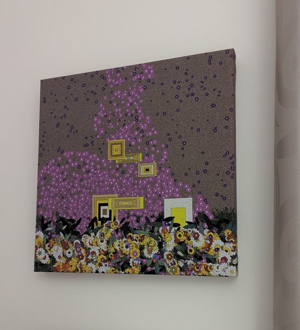 A piece of artwork displayed on a wall featuring a textured composition with a purple particle pattern on a brown background, geometric gold elements in the center, and a colorful floral border at the bottom.