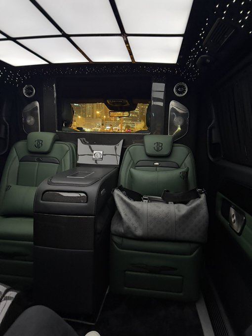 The image displays the luxurious interior of a vehicle featuring green leather seats branded with the "BB" logo (Brabus), a starlight headliner, and ambient lighting, with a Louis Vuitton bag resting on one of the seats. The "Gm" caption pairs well with this opulent setting, as the wealthy lifestyle and luxury branding suggest a stylish "Good Morning" vibe.