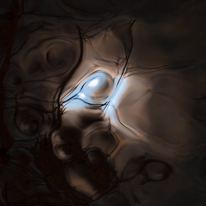 An abstract dark artwork with a glowing central light source reflecting off wavy, metallic surfaces and intricate thin lines.