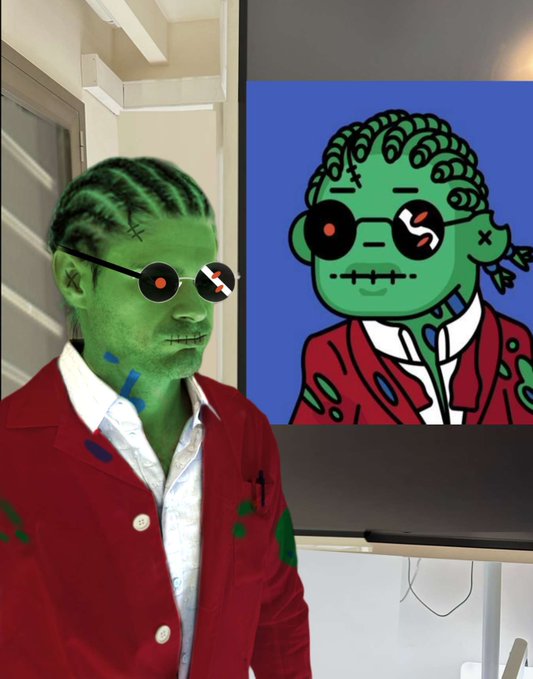 A person with green-painted skin and face modified to look like a cartoon character, standing next to a TV displaying the same cartoon character.