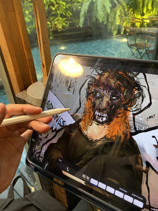A hand uses an Apple Pencil to digitally paint a dark, toothy portrait on an iPad Pro (with "Settings" and "Add Frame" buttons visible on screen) at an outdoor poolside café, matching the weekend creative vibes of the "GM! happy weekend everyone!" greeting.