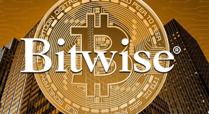 The image shows a large golden Bitcoin coin with the word "Bitwise" prominently displayed in white text across the center, set against a backdrop of skyscrapers with digital circuit patterns. The visual reinforces the post's message about Bitwise's bullish Bitcoin price prediction, with the prominent Bitwise branding and Bitcoin imagery visually connecting the asset management firm's $1.3 million BTC forecast to the cryptocurrency itself.