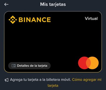 A screenshot of a Binance app interface in Spanish, showing a virtual credit card ('Mis tarjetas') with options to view card details and add the card to a mobile wallet.