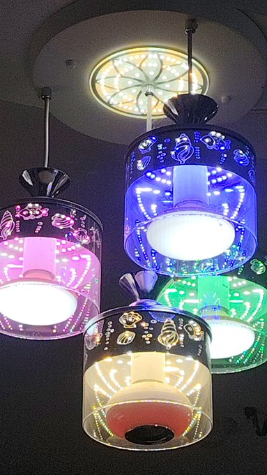 The image features four colorful hanging lights with unique designs that are illuminated by white light bulbs. These lights are suspended from the ceiling at various heights, creating an interesting visual effect as they cast their glow throughout the room. The lights have a circular pattern on them, adding to their aesthetic appeal. The post includes text about the importance of fresh air and natural light in the morning, which could be related to the colorful lights or simply a random connection made by the viewer.
