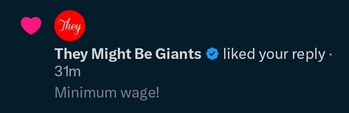 A screenshot of a Twitter notification showing that 'They Might Be Giants' with a verified checkmark liked a reply saying 'Minimum wage!'