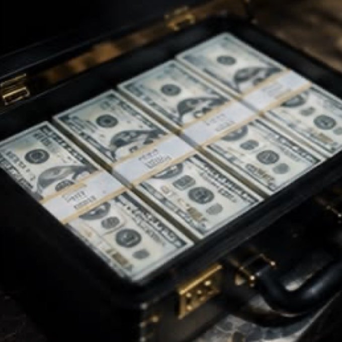 An open black briefcase is filled with neatly bundled stacks of U.S. dollar bills secured with currency straps.