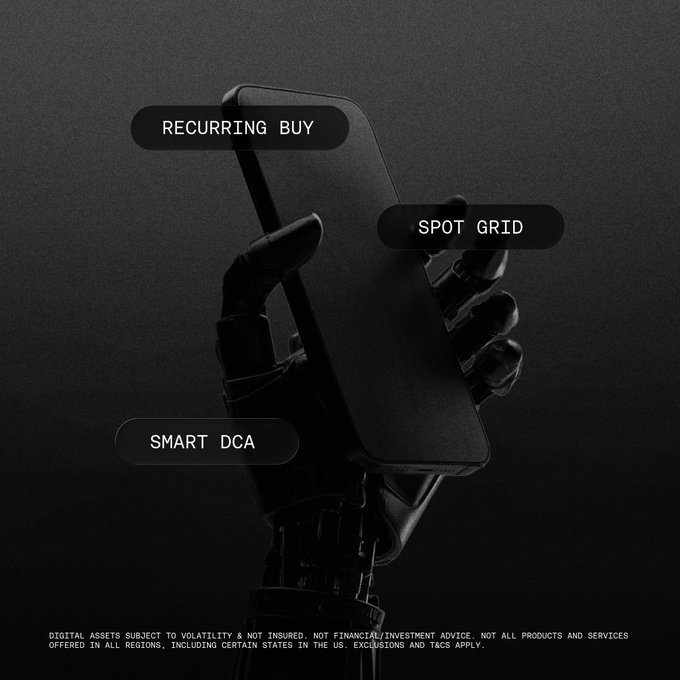A robotic hand holds a smartphone against a dark background, overlaid with three feature labels: "RECURRING BUY," "SPOT GRID," and "SMART DCA," accompanied by a financial disclaimer at the bottom. The image visually reinforces the post's message by symbolizing automated, hands-off crypto trading strategies, with the robotic hand representing the "set it once" automation that eliminates manual effort.