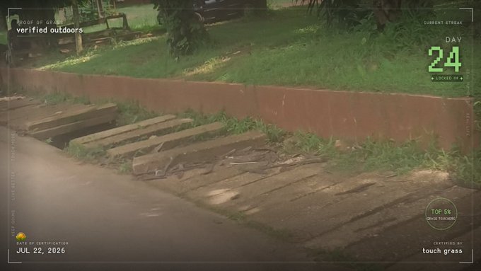 CCTV-style surveillance footage dated JUL 22, 2026 labeled 'PROOF OF GRASS — verified outdoors,' showing wooden planks on grass with overlays indicating 'DAY 24,' 'LOCKED IN 4,' and 'TOP 5%.'