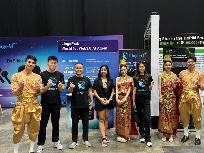 A group photo of seven people, including individuals in traditional Thai attire, posing in front of banners promoting "LingoAI" and "LingoPod: World 1st Web3.0 AI Agent."