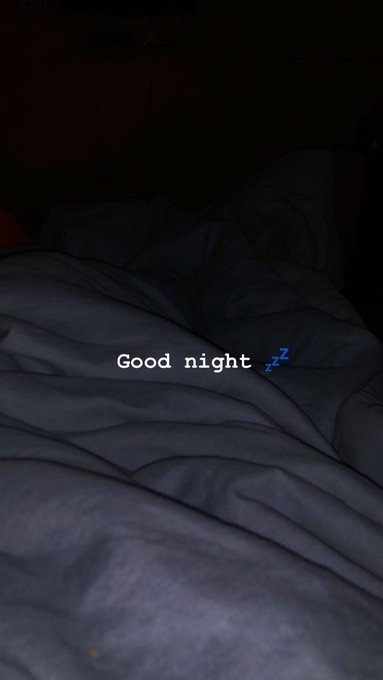A dark, dimly lit photo of rumpled bedsheets with white text reading 'Good night' and a blue 'Zzz' emoji overlaid in the center.