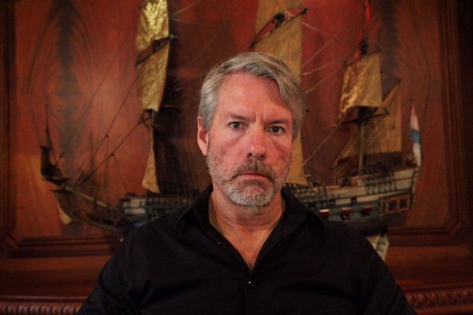 A man with gray hair and a goatee, wearing a black shirt, sits in front of an ornate wooden wall featuring a detailed model sailing ship. The accompanying post suggests this is Michael Saylor, the prominent Bitcoin advocate and founder of Strategy (formerly MicroStrategy), delivering a bullish statement about acquiring the remaining 1,000,000 bitcoins.