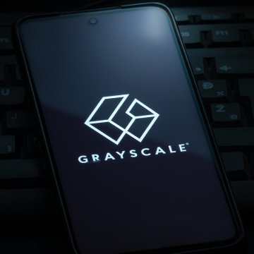 A smartphone displaying the "GRAYSCALE" logo rests on a keyboard, illustrating the crypto asset manager's commentary that the CLARITY Act is unlikely to pass this year.