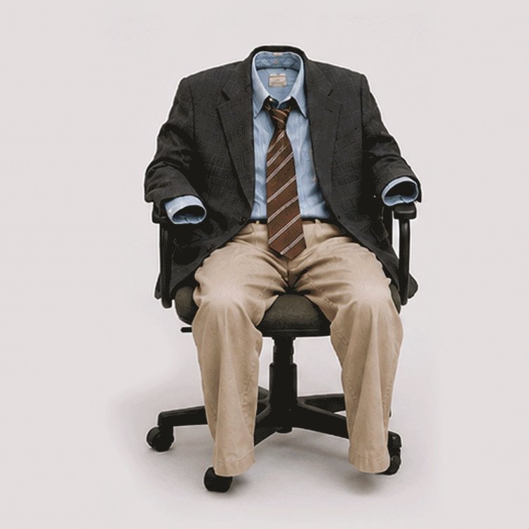 The image features a man sitting in an office chair, wearing a suit jacket and tie. The background of the image is white, which makes the man's attire stand out prominently. There are no other objects or people visible in the image, and the focus is solely on the man dressed in business attire.