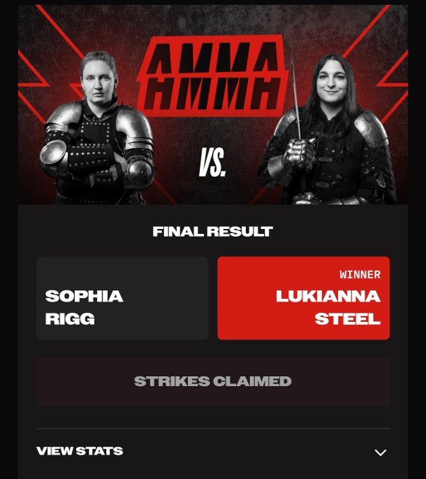 The image shows two women dressed up as medieval characters with swords, standing against a red background. The text "Amma HMMH" is displayed above them, indicating that they are participating in an event related to the video game "Amma". The post also mentions that the players have claimed 5 strikes and 10 predictions for their victory.
