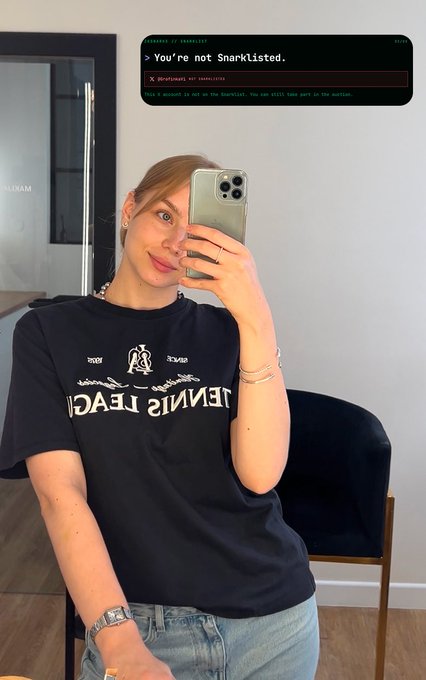 A woman takes a mirror selfie wearing a black 'Tennis de Teca' t-shirt, while a terminal screenshot overlay reads '> You're not ShArklisted.' with 'DEVELOPMENT NOT COMPLETED' and 'This is concept is not on the shortlist. You can still take part in the auction.'