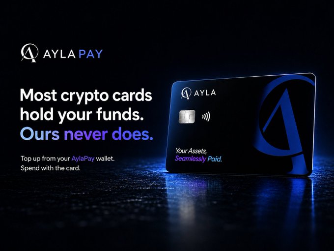 A promotional image for AylaPay featuring a sleek black and blue credit card with the tagline "Most crypto cards hold your funds. Ours never does." along with the text "Top up from your AylaPay wallet. Spend with the card." and "Your Assets, Seamlessly Paid." on the card itself, highlighting its non-custodial approach to crypto spending.