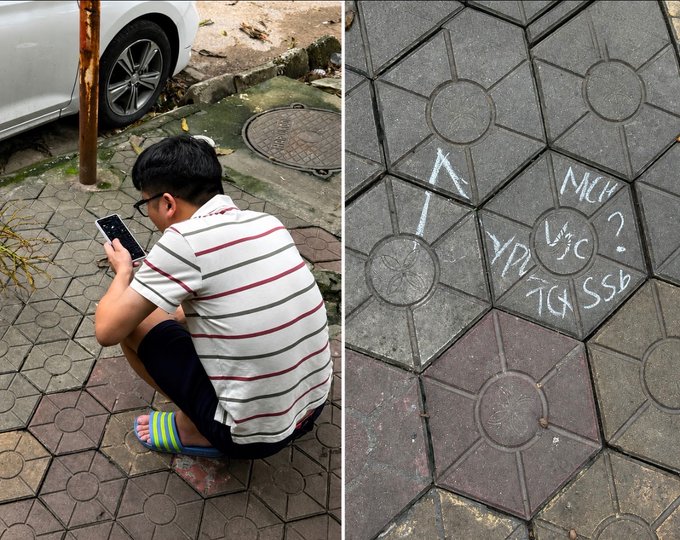 A split image showing a young man in a striped shirt squatting on a tiled sidewalk using his phone next to a parked car, alongside a close-up of chalk writings on the pavement reading 'AI MÌNH?' and 'ĐỪNG AGSSB' with an arrow pointing toward the man's direction.
