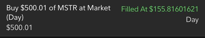 A stock trade confirmation showing a market buy order of $500.01 worth of MSTR executed at $155.81601621 per share. This visually documents the user's recent purchase of approximately 3.2 additional shares toward their goal of accumulating 100 shares of MicroStrategy.
