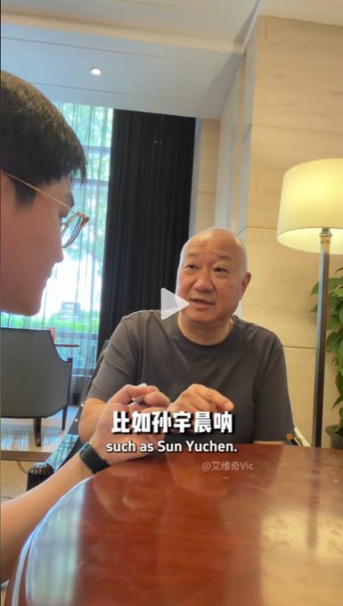 A video still shows a man in a gray t-shirt being interviewed in what appears to be a hotel lounge, with a play button overlay and the subtitle "比如孙宇晨 / such as Sun Yuchen." The image visually supports the post's claim by showing a speaker (likely Feng Lun, 冯仑) mentioning Sun Yuchen by name during a discussion.