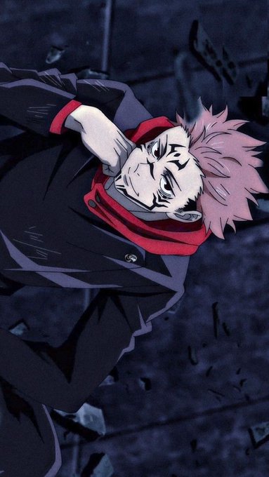 The image features a man with pink hair wearing a black jacket and red scarf, sitting down and looking at his phone. The background of the image is dark blue, which contrasts with the man's outfit. There are no texts or other objects present in the image.