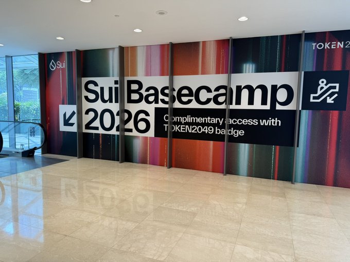 A lobby entrance features a large "Sui Basecamp 2026" banner advertising complimentary access with a TOKEN2049 badge.