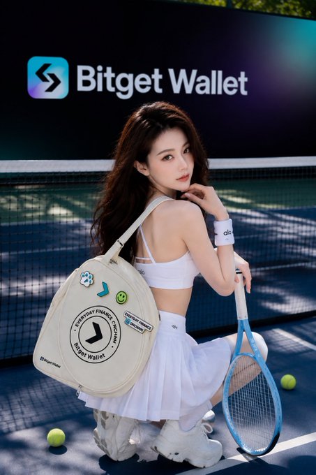 A promotional advertisement for Bitget Wallet featuring a woman in tennis attire posing with a branded tennis bag and racket on a tennis court.