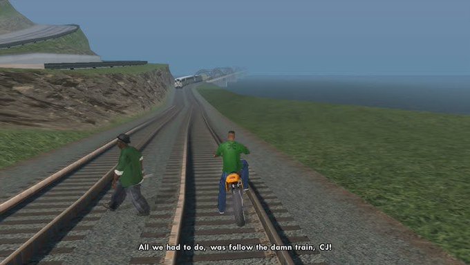 A video game screenshot showing two characters in green shirts and one on a motorcycle walking along train tracks, with the subtitle 'All we had to do, was follow the damn train, CJ!'.