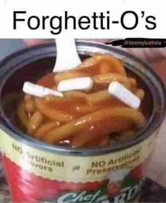 A can of Chef Boyardee 'Forghetti-O's' pasta with visible text reading 'No Artificial Flavors = No Artificial Preservatives', shown with a white fork lifting sauce-covered pasta rings topped with cheese chunks.