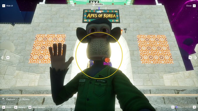 A video game screenshot showing a monkey character in a green uniform waving at the camera, with a sign reading 'APES OF KOREA' in the background.
