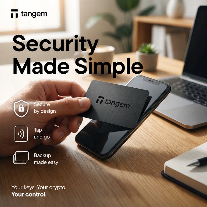 A promotional advertisement for Tangem hardware crypto wallet featuring the text 'Security Made Simple' with bullet points 'Secure by design', 'Tap and go', and 'Backup made easy', showing a hand tapping a Tangem card on a smartphone.