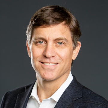 A professional headshot shows Chris Perkins smiling warmly in a dark blazer and white shirt against a gray background, complementing the post's reference to his insights on crypto regulation and his role as Head of Franklin Crypto.