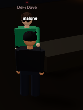 A Roblox-style game screenshot showing two player avatars labeled 'DeFi Dave' and 'malone' in a dark environment.