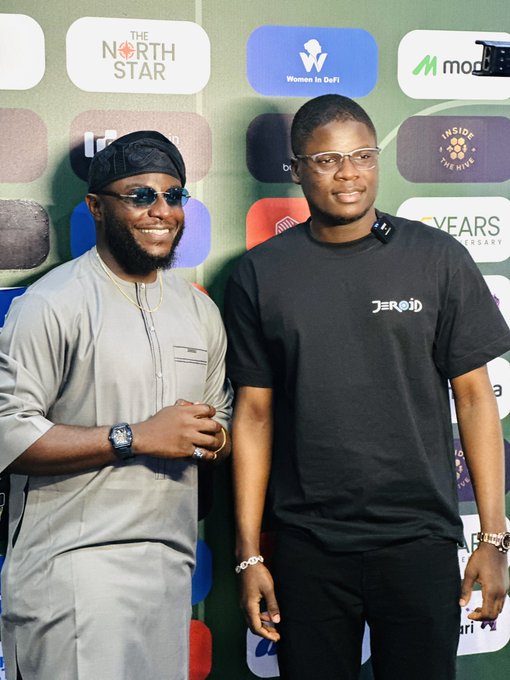 Two men pose together at a media event backdrop featuring logos for "The North Star," "Women In DeFi," "Modulr," and "INSIGHTS/ME TIME." The hashtag "#UnchainSummer26 files" suggests this image documents attendees at a crypto or blockchain-related summer conference.