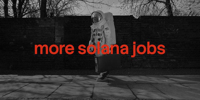 A black-and-white photo of an astronaut in a spacesuit standing against a brick wall, overlaid with red text reading "more solana jobs".