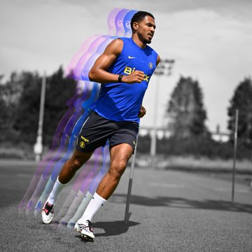 A composite photograph showing a man in a blue Brazil football jersey sprinting on a track, overlaid with a motion blur effect of purple and blue streaks.