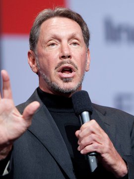 Larry Ellison, co-founder and chairman of Oracle, speaks into a microphone while gesturing during what appears to be a public address or keynote event. The image relates to the post as Ellison is a prominent figure associated with Oracle, the company that has just released Java 27 with enhanced post-quantum cryptography support.