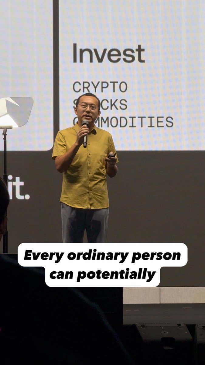 A speaker in a yellow shirt presents on stage with a slide behind him reading "Invest" followed by "CRYPTO," "STOCKS," and "COMMODITIES," with a caption overlay stating "Every ordinary person can potentially." The image visually reinforces the post's message about OKX's evolution beyond a traditional crypto exchange into a broader investment platform.