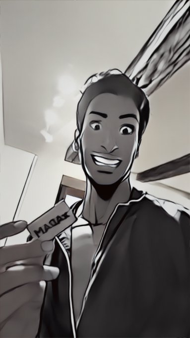 A black and white comic-style illustration shows a smiling man with short hair holding a card or device that reads 'MACAW'. The image has heavy line art and dramatic shading.