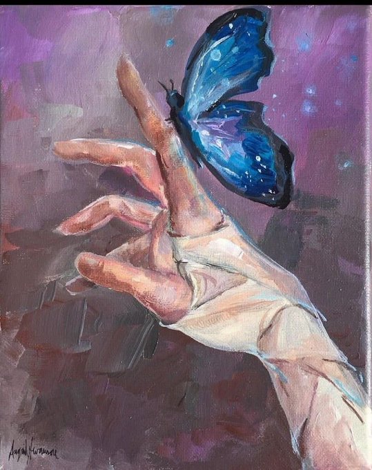 An expressive painting showing two hands gently touching a vibrant blue butterfly against a purple-toned background, with the artist's signature 'Joyce Kuijpers' in the lower left.